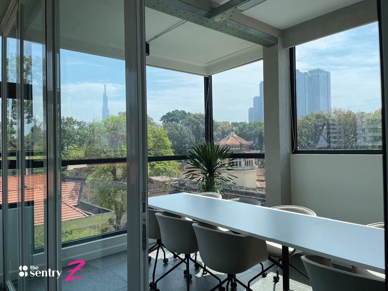 A bright, modern meeting room with a view of a cityscape.