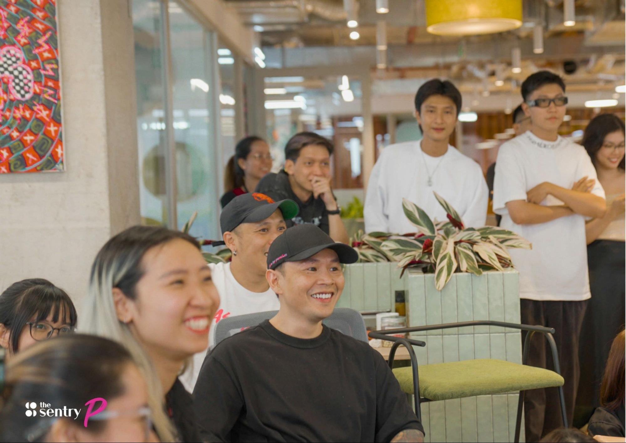 Group of people attentively participating in an event at a coworking space.