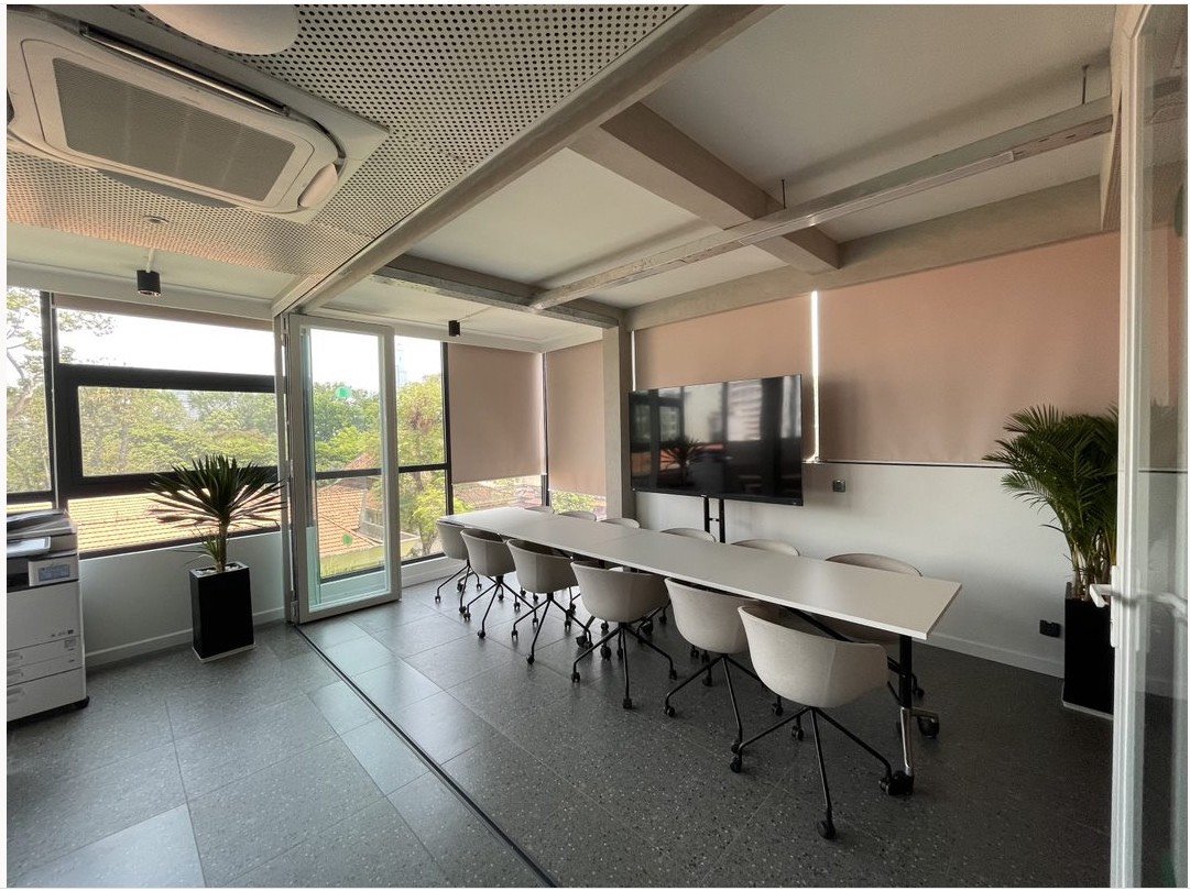 A conference room with a large TV and modern furnishings.