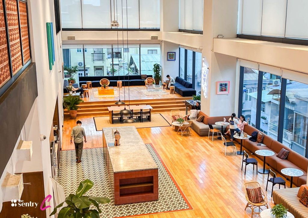 A stylish and comfortable coworking lounge area with modern furniture and city views. 