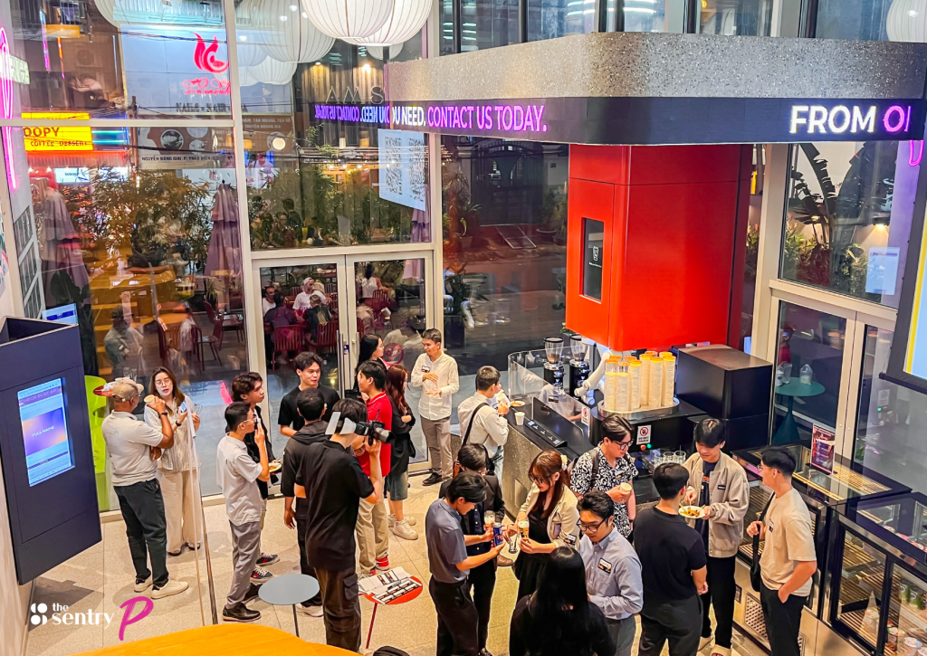 Professionals networking in a vibrant common area of a coworking space.