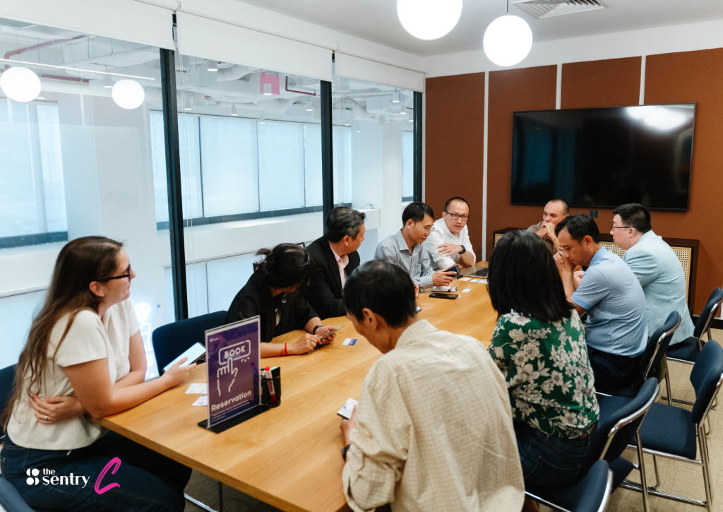 A small, informal meeting room with comfortable chairs and a whiteboard for brainstorming.