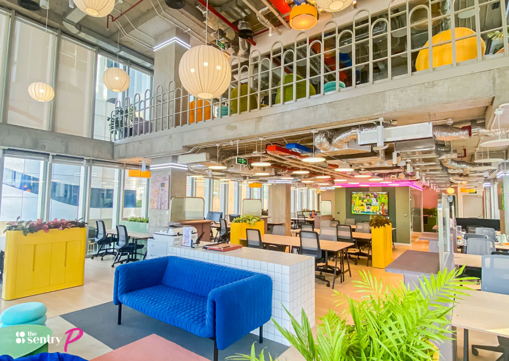 Wide shot of a modern open-plan office with shared desks.