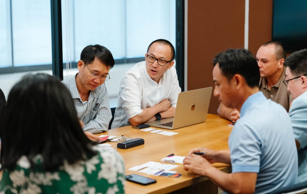 A group of professionals having a meeting inside a meeting room.