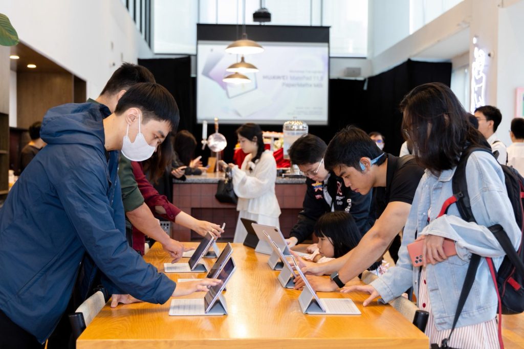 Small group collaborating on laptops in a casual lounge area.