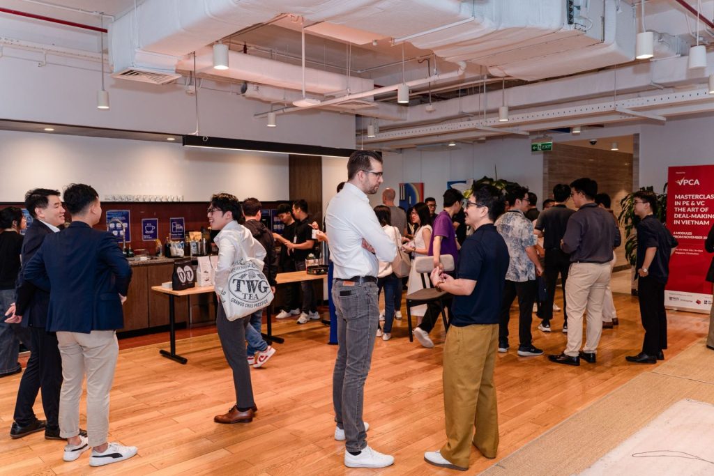 Group of people chatting and laughing during a networking event.
