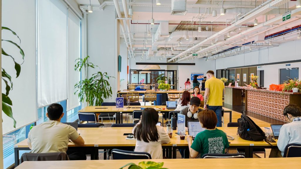 People sitting on a sofa or breakout area looking at a laptop together.