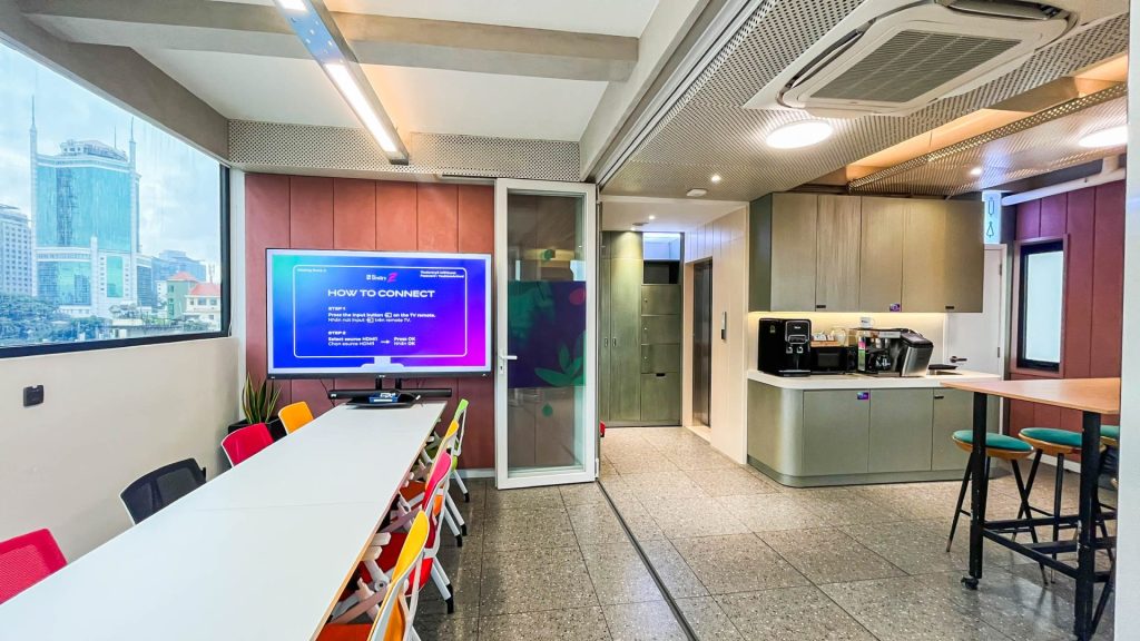 Modern office pantry with espresso machine and tea selection.