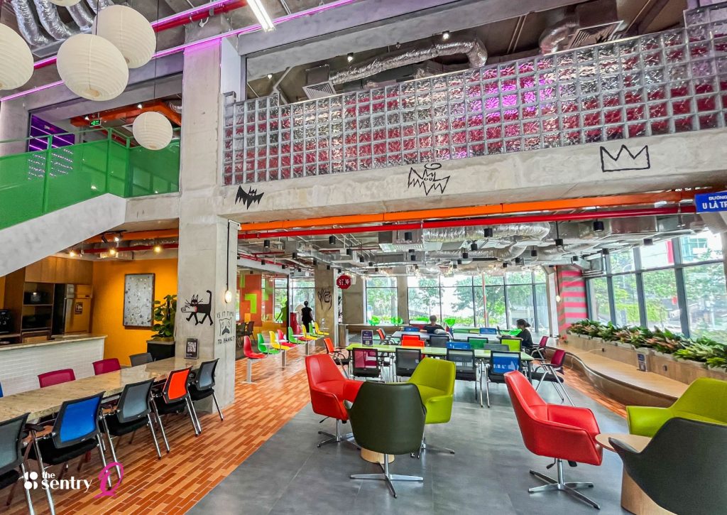 Person wearing noise-canceling headphones while working in a busy area.