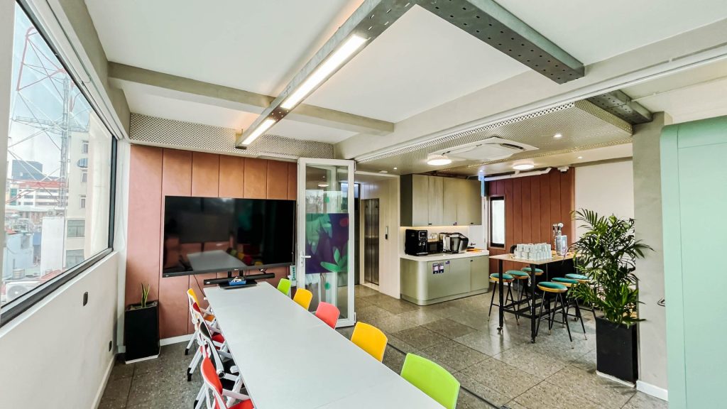 Tech-enabled meeting room with video conferencing screens.