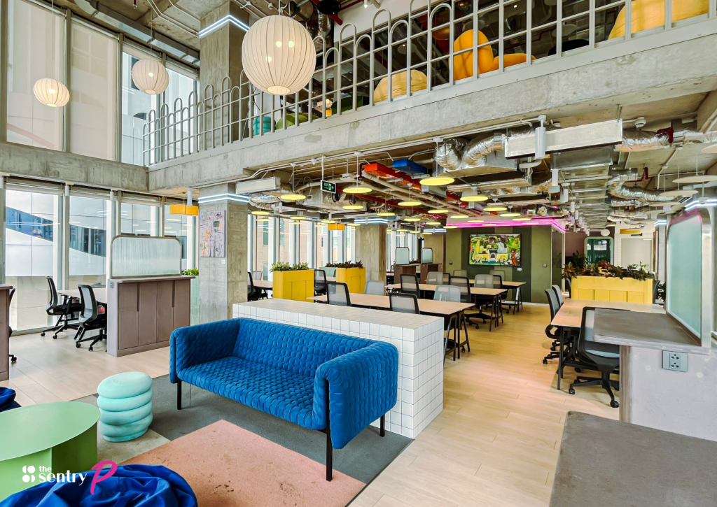 Comfortable sofa seating in a relaxed breakout area away from desks.