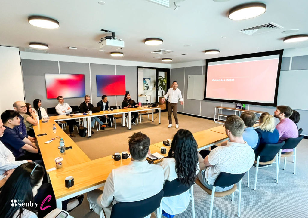 A hot-desking area filled with professionals working diligently.