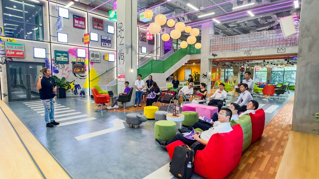 A bright, open-plan workspace showing a mix of hot desks and lounge seating.