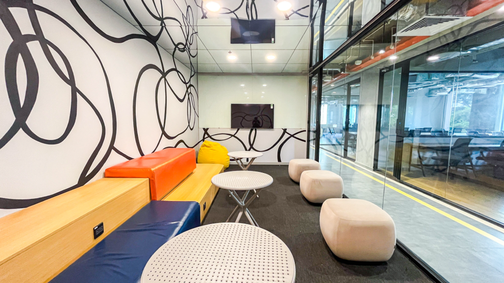 Modern, acoustically treated meeting room with a solid door and professional presentation setup.