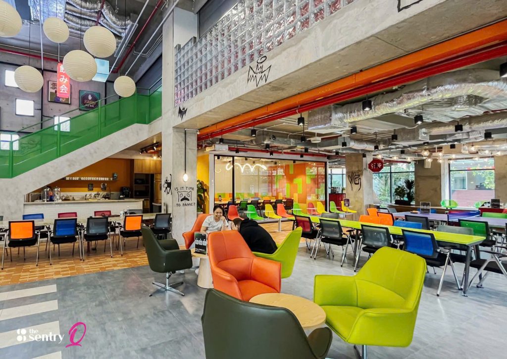 <image> Alt text: Collaborative workspace featuring shared desks and modern office amenities.