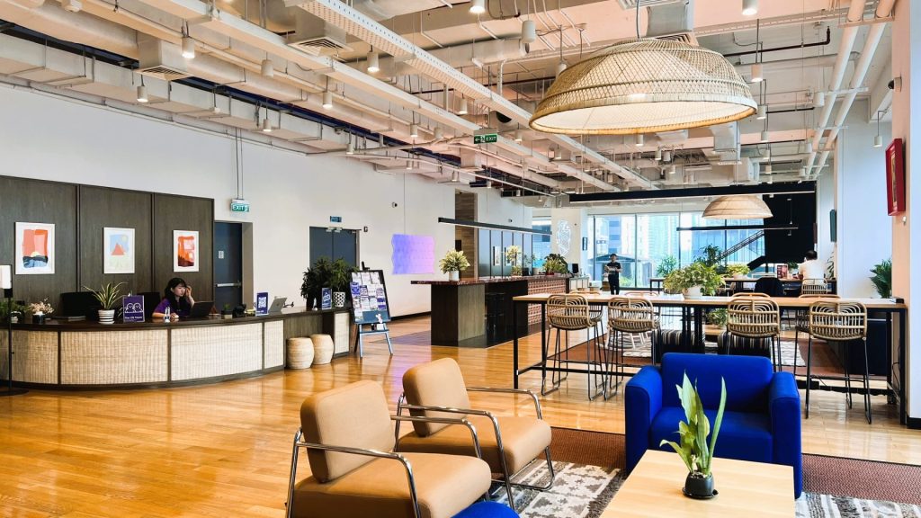 A high-end reception desk with a professional receptionist and the building’s branding clearly visible.