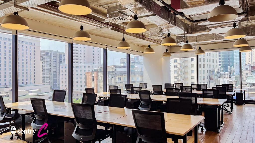 A glass-walled private office suite showing a team at work.