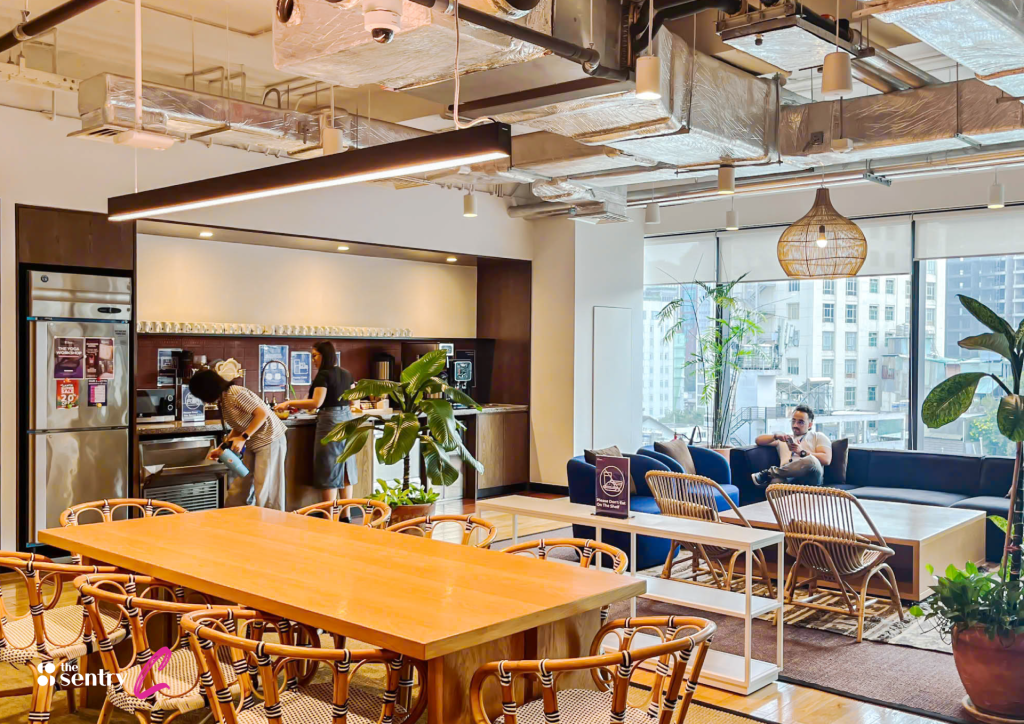 <image>
Alt text: A group of professionals in an informal discussion in a coworking common area