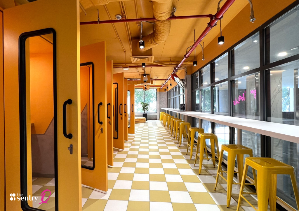 The Sentry coworking area showing open desks alongside enclosed meeting pods and phone booths