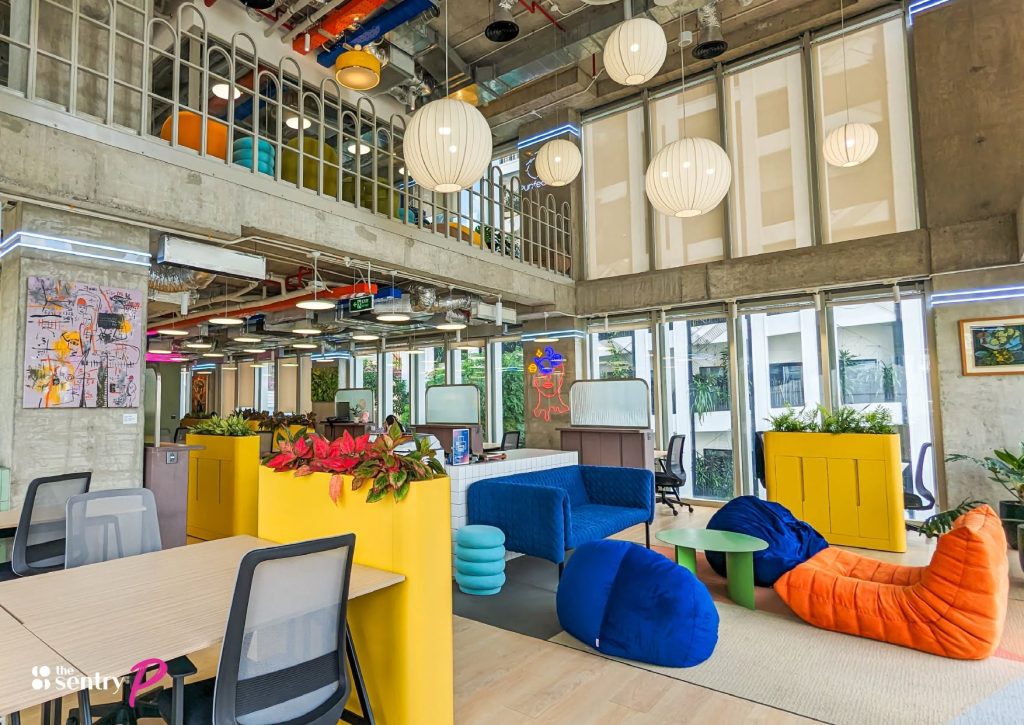 Mix of coworking desks and private offices across a The Sentry floor.