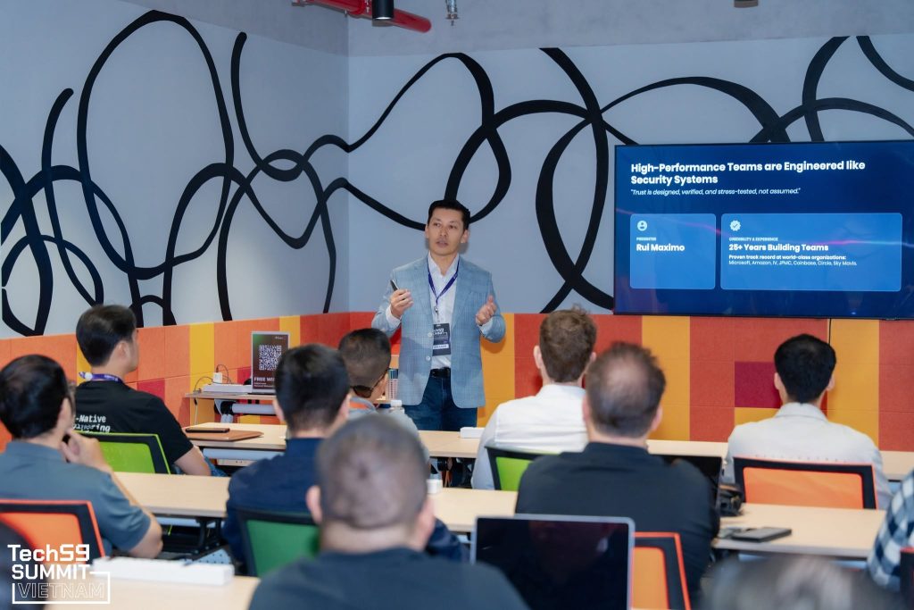 An international team of local and foreign professionals collaborating in a glass-walled meeting space.