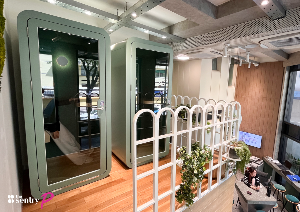 A focused professional working independently in a soundproof office pod.