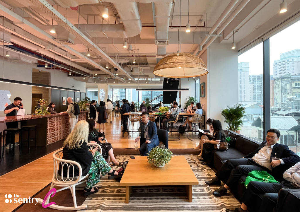 Team members working inside a private glass-walled office suite.