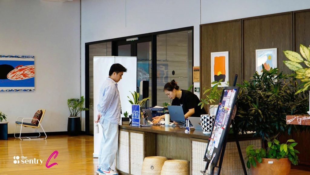 A professional front desk reception area inside a serviced office building.