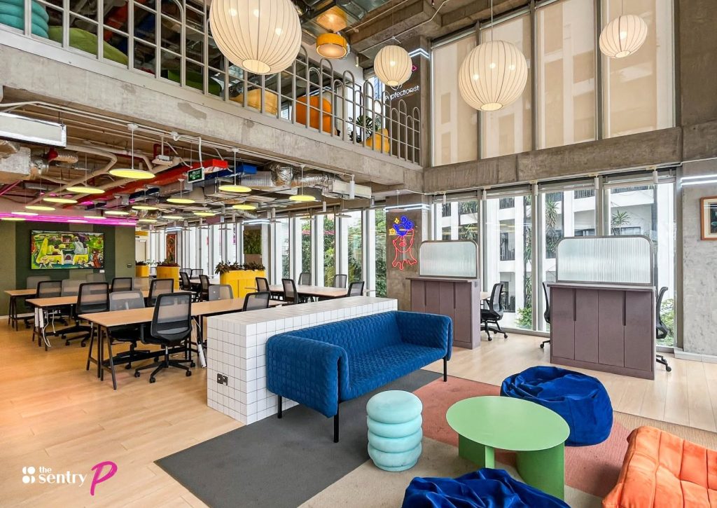 A spacious view of flexible workstations and private office suites inside a modern coworking facility in Ho Chi Minh City.
