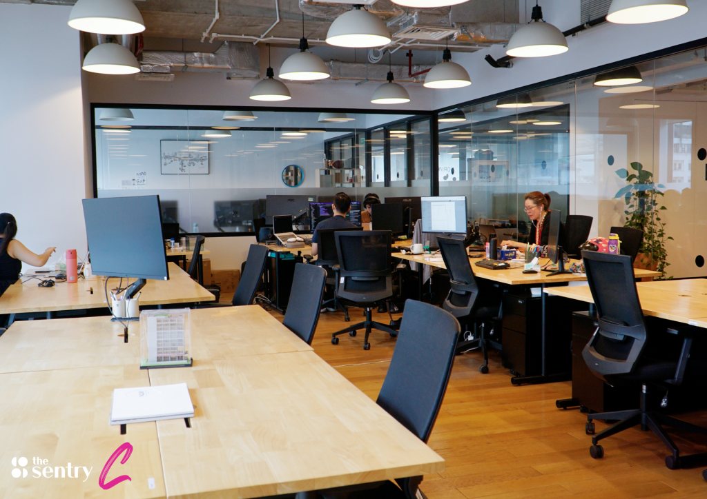 Open-plan coworking desks at The Sentry with professionals at work