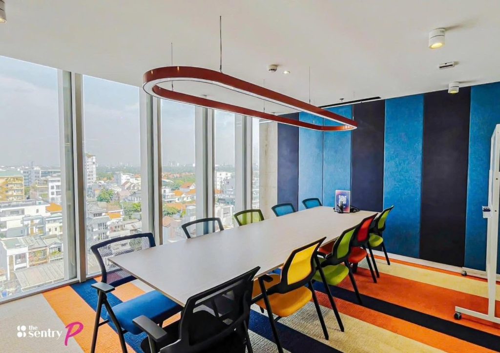 Glass-walled private meeting room with a conference table and city view