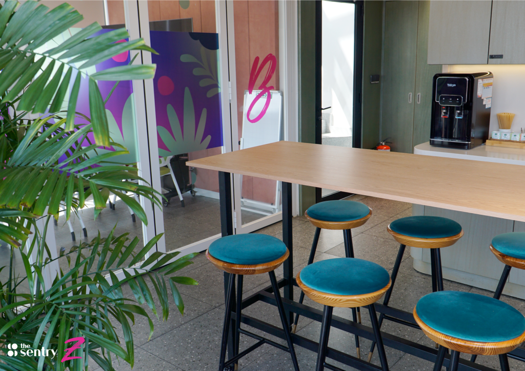 Lounge and kitchen area at The Sentry with comfortable seating and a coffee counter