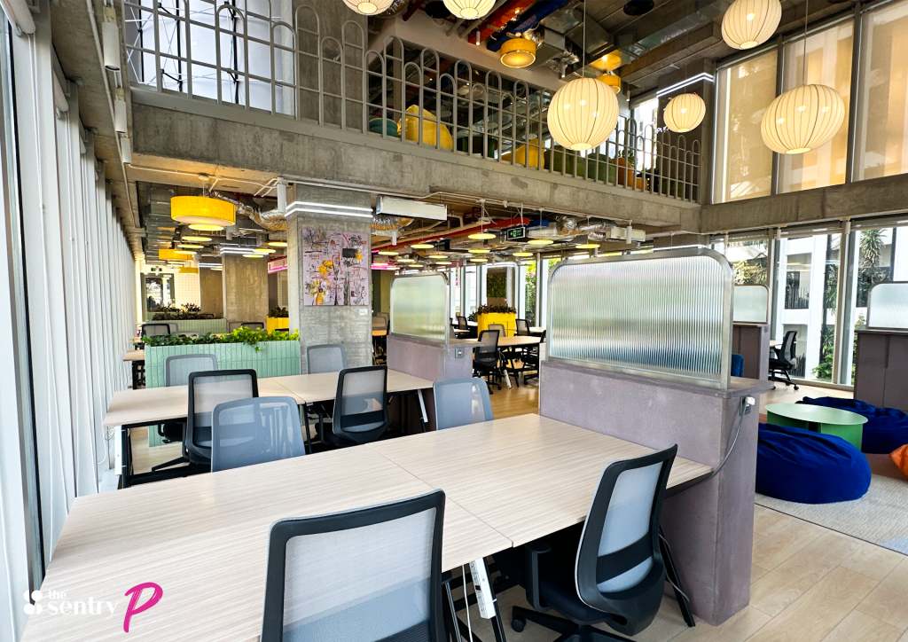 Open coworking floor with rows of desks at The Sentry