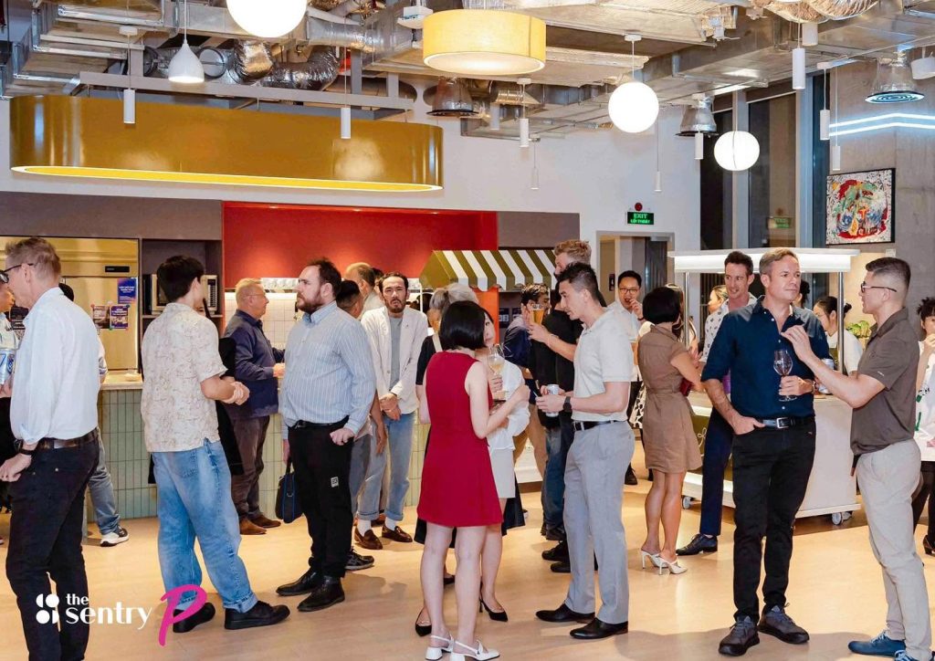 Members networking at a community event at The Sentry coworking space